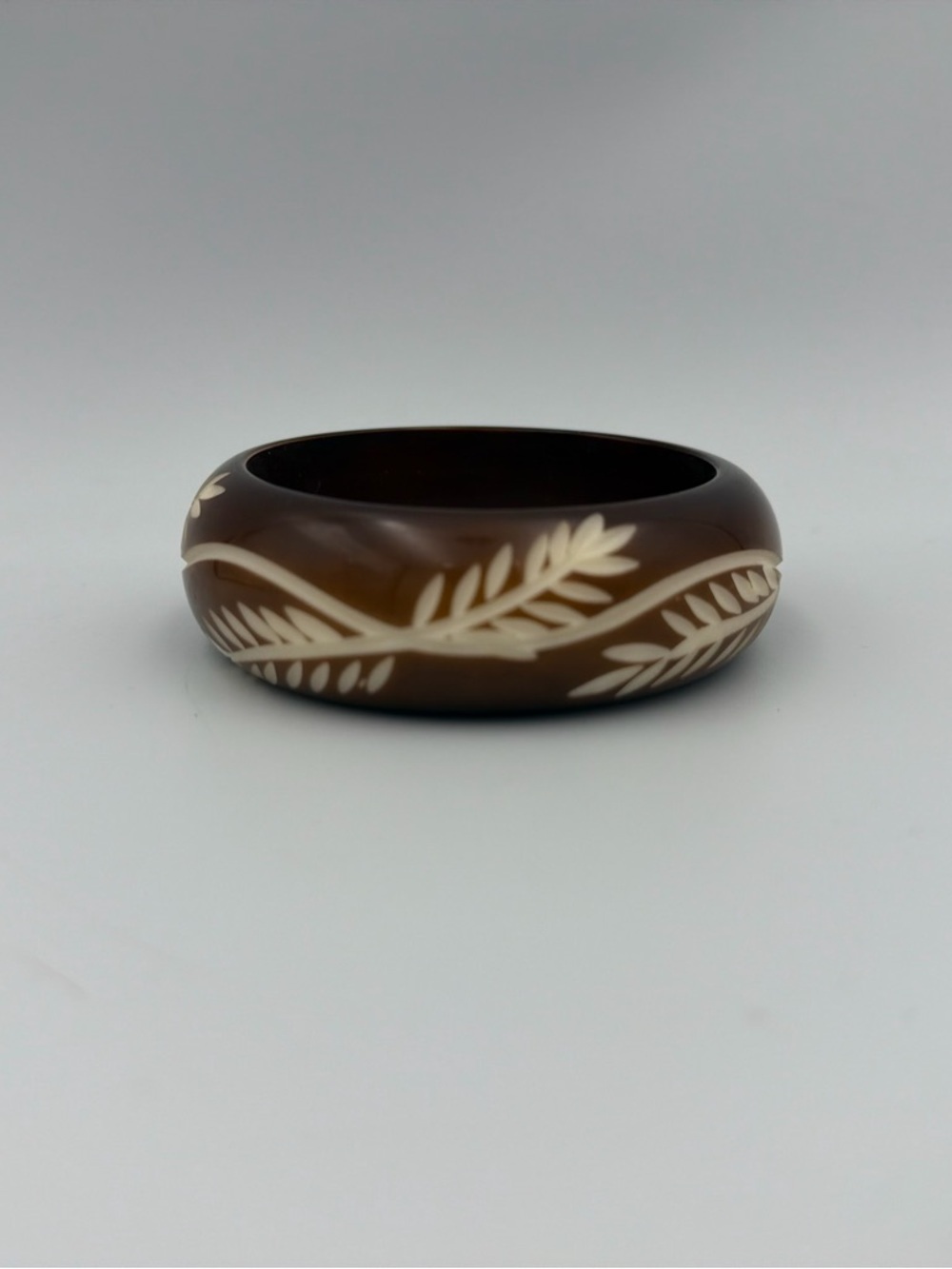 Brown Bracelet with Carved Cream Leaf Motif